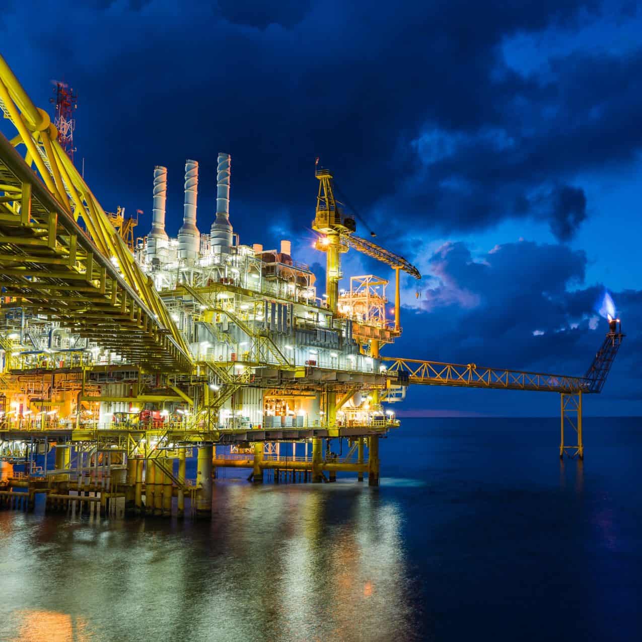 Panorama of oil and gas central processing platform in sun set where produced, treat the hydrocarbon then sent to refinery , petrochemical , power generation plant and tanker barge for export.